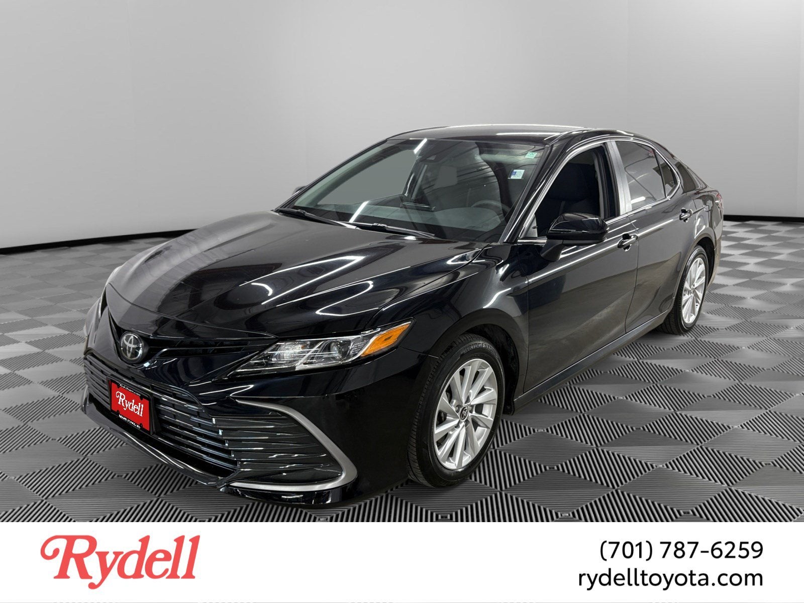 2023 Toyota Camry LE in Midnight Black — front three-quarter view